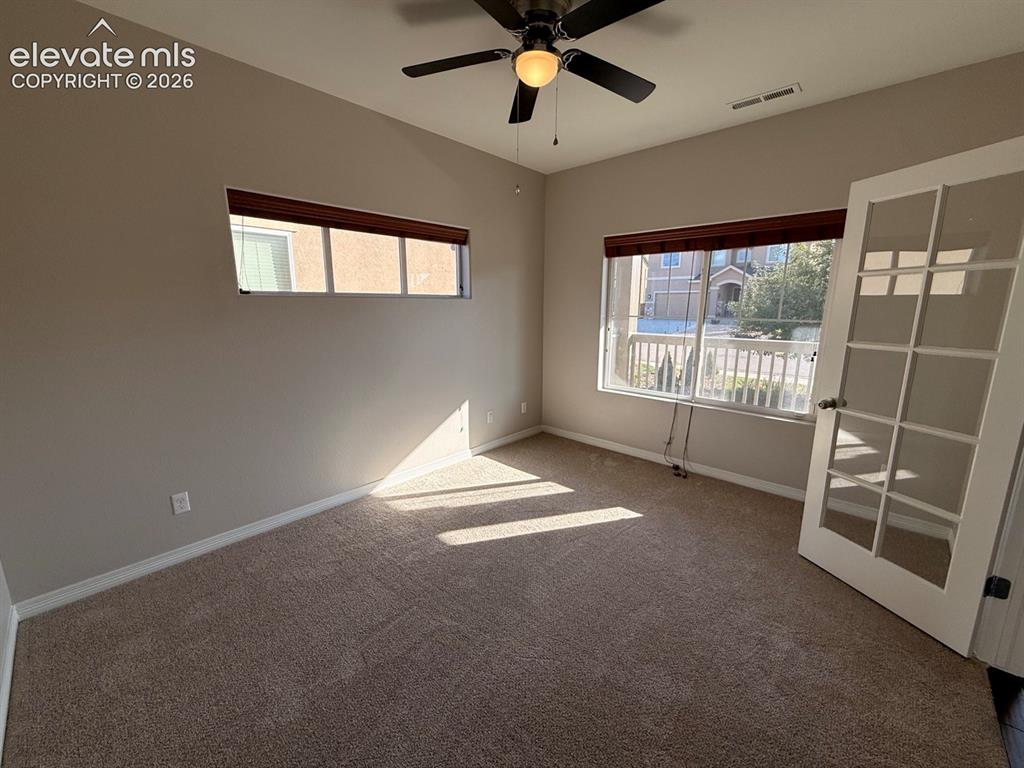 Image 5 of 50: Recessed window, ceiling fan with integrated lighting, glass-paneled door,