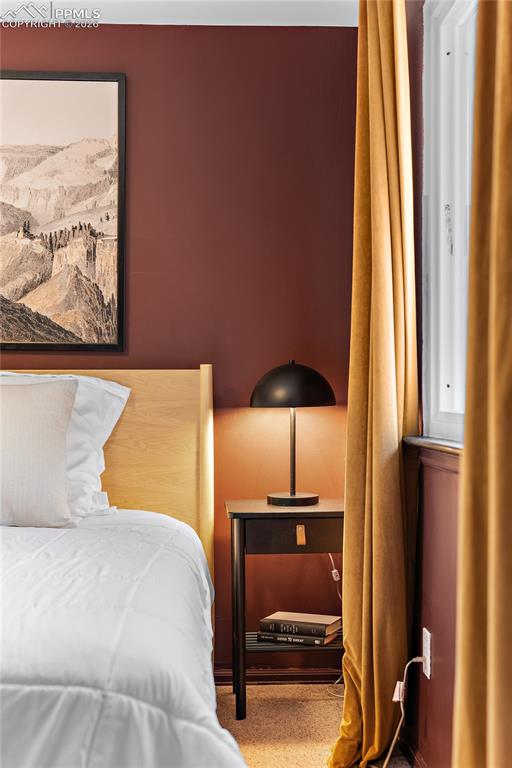 Image 20 of 45: Sitting room with a tile fireplace and carpet