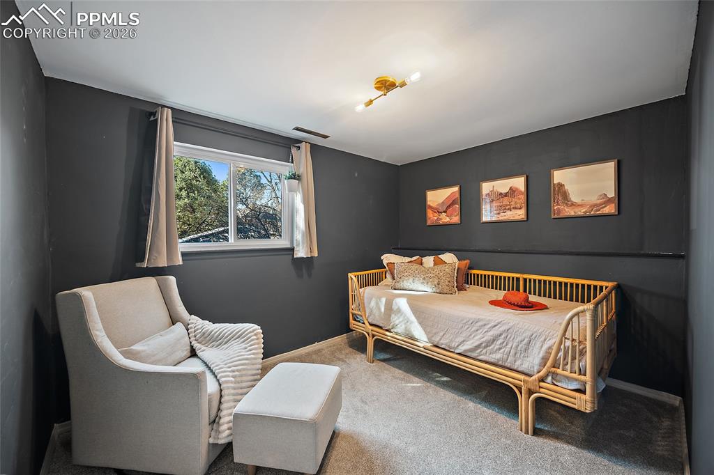 Image 32 of 45: Living area with carpet flooring and natural light