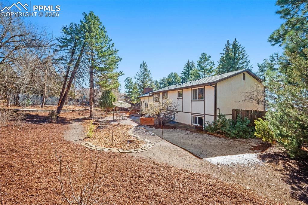 Image 37 of 45: Rear view of house featuring a chimney, a patio area, outdoor dining area, 