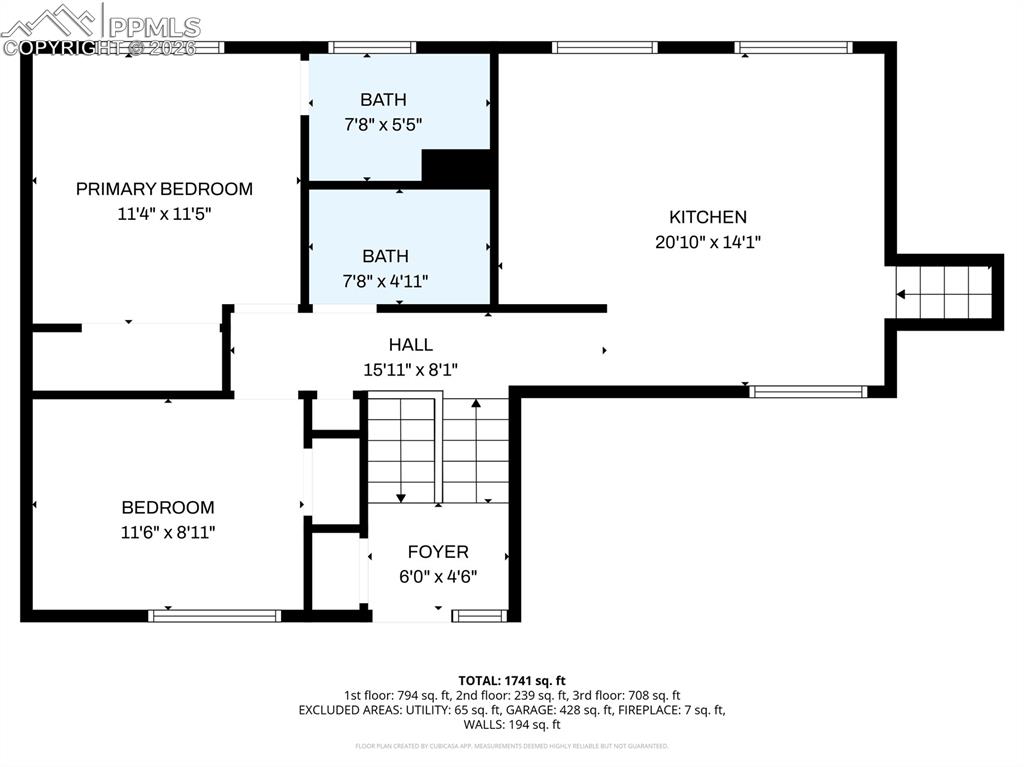 Image 44 of 45: Film photo of the home in the spring. View of side of property with stucco 