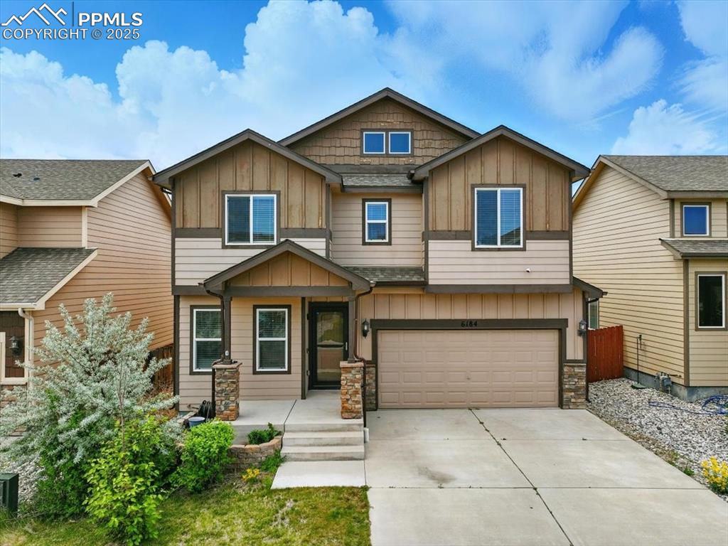 Image 1 of 46: Craftsman inspired home featuring board and batten siding, concrete drivewa