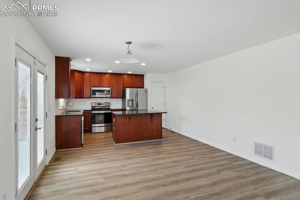 Image 11 of 46: Kitchen with stainless steel appliances, plenty of natural light, recessed