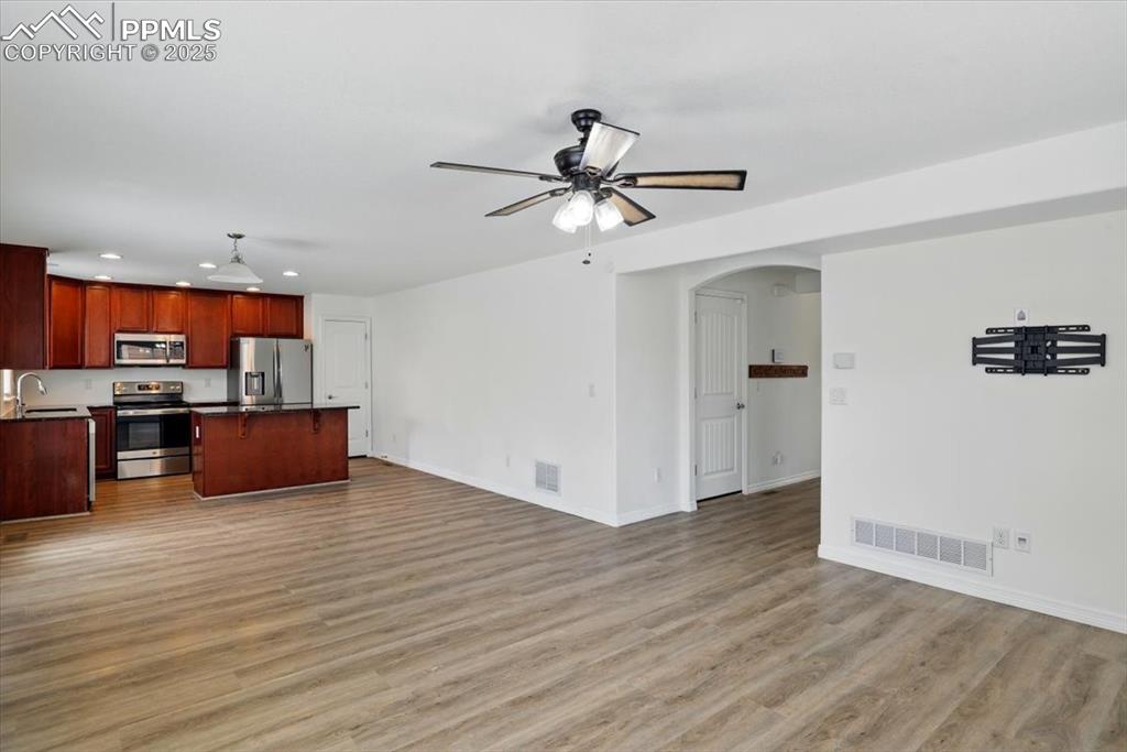 Image 12 of 46: Kitchen with appliances with stainless steel finishes, open floor plan, rec