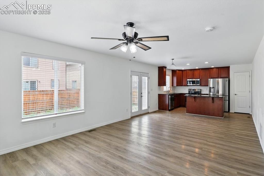 Image 13 of 46: Kitchen with stainless steel appliances, a sink, open floor plan, dark coun