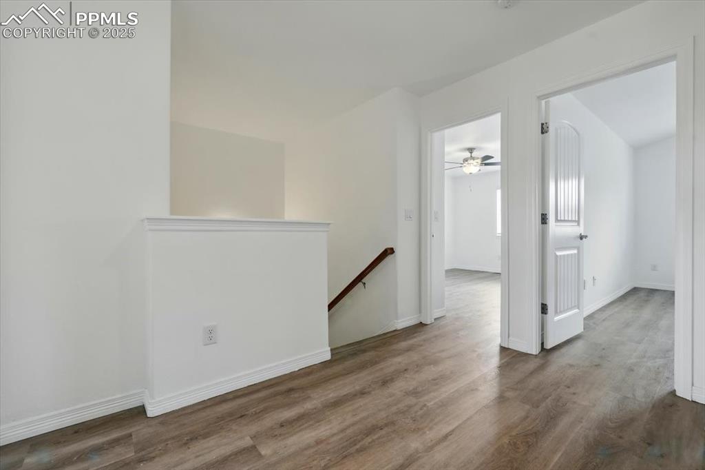 Image 14 of 46: Empty room with wood finished floors and baseboards