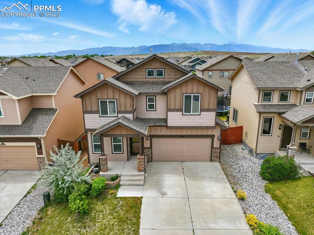 Image 2 of 46: Craftsman house featuring board and batten siding, stone siding, a mountain