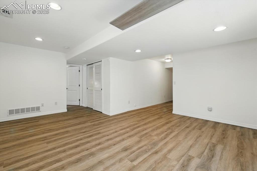 Image 29 of 46: Empty room with baseboards, light wood-style flooring, and recessed lightin