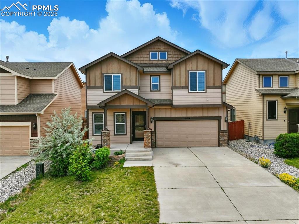 Image 3 of 46: Craftsman inspired home featuring board and batten siding, stone siding, an