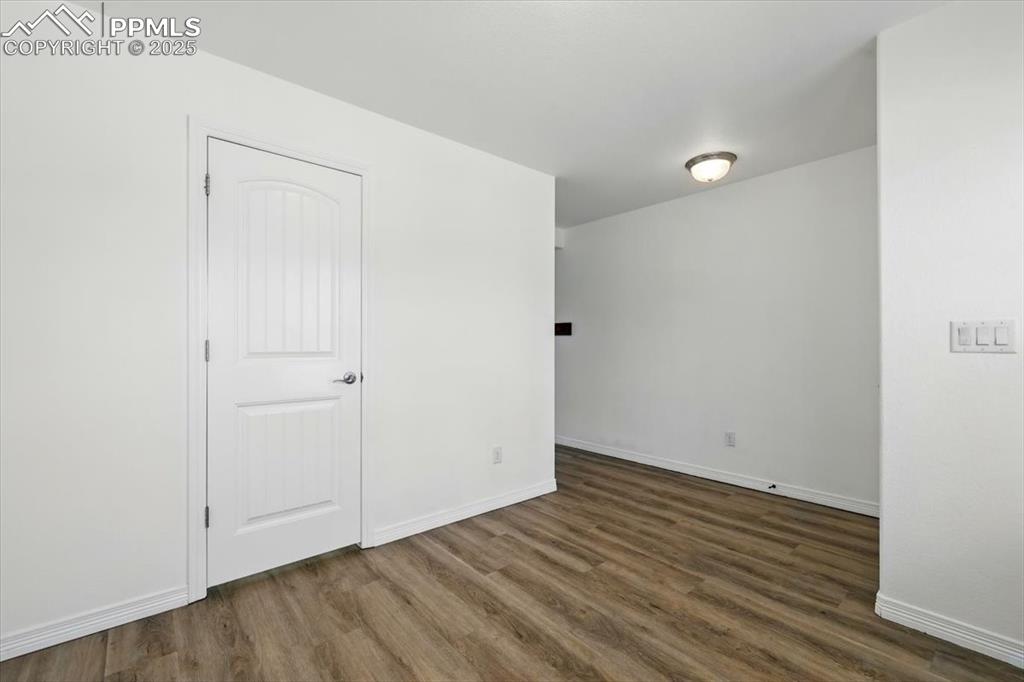 Image 37 of 46: Empty room with wood finished floors and baseboards