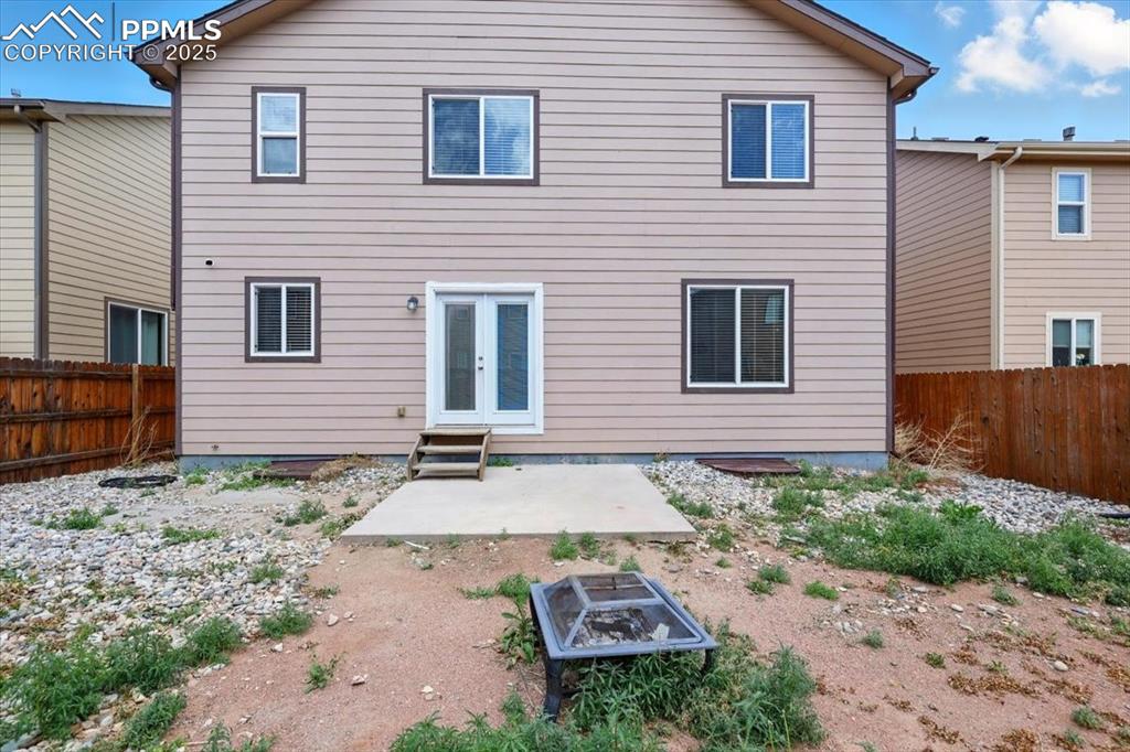 Image 40 of 46: Back of house featuring a fenced backyard, a patio, french doors, and entry