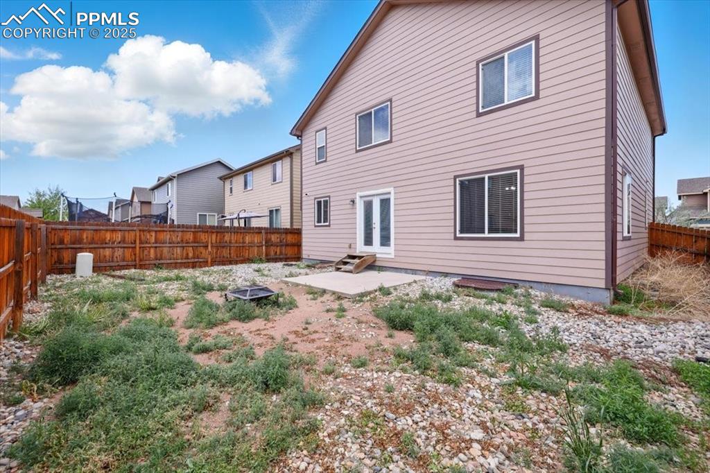 Image 41 of 46: Back of property featuring a patio, a fenced backyard, and french doors
