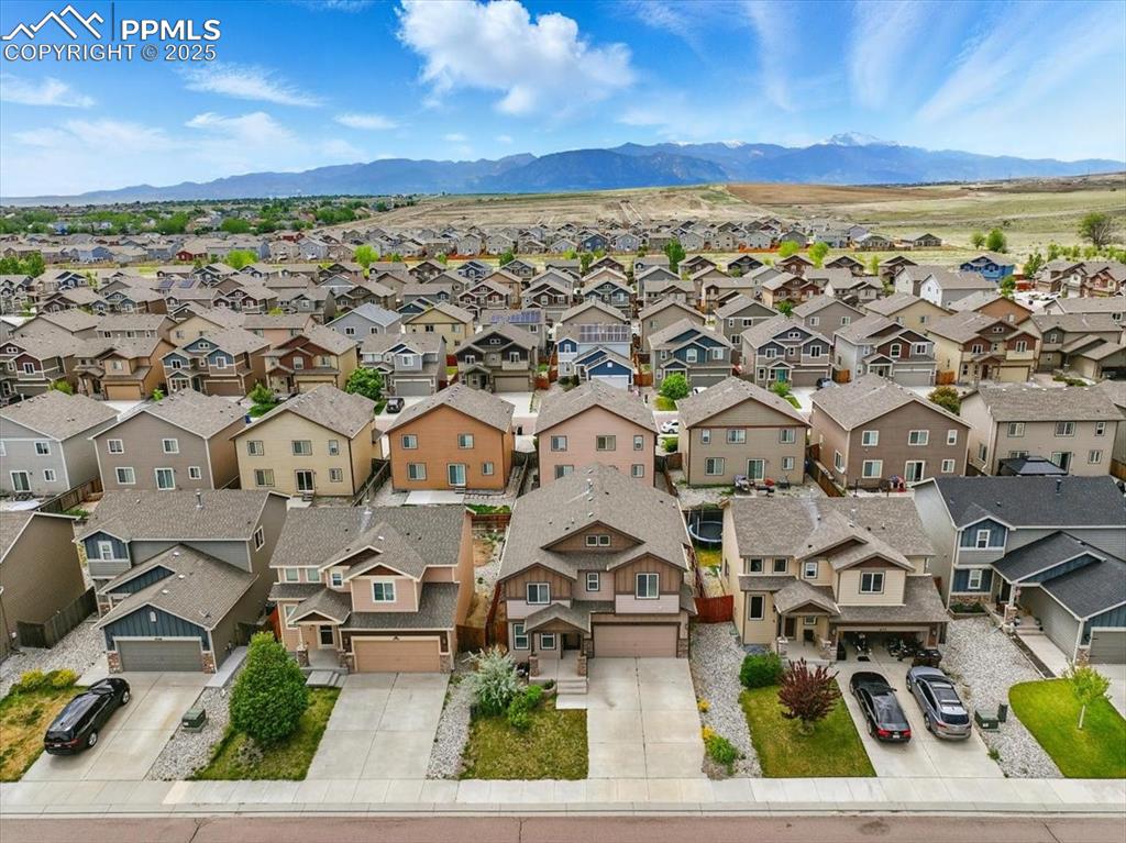 Image 44 of 46: Aerial perspective of suburban area with mountains