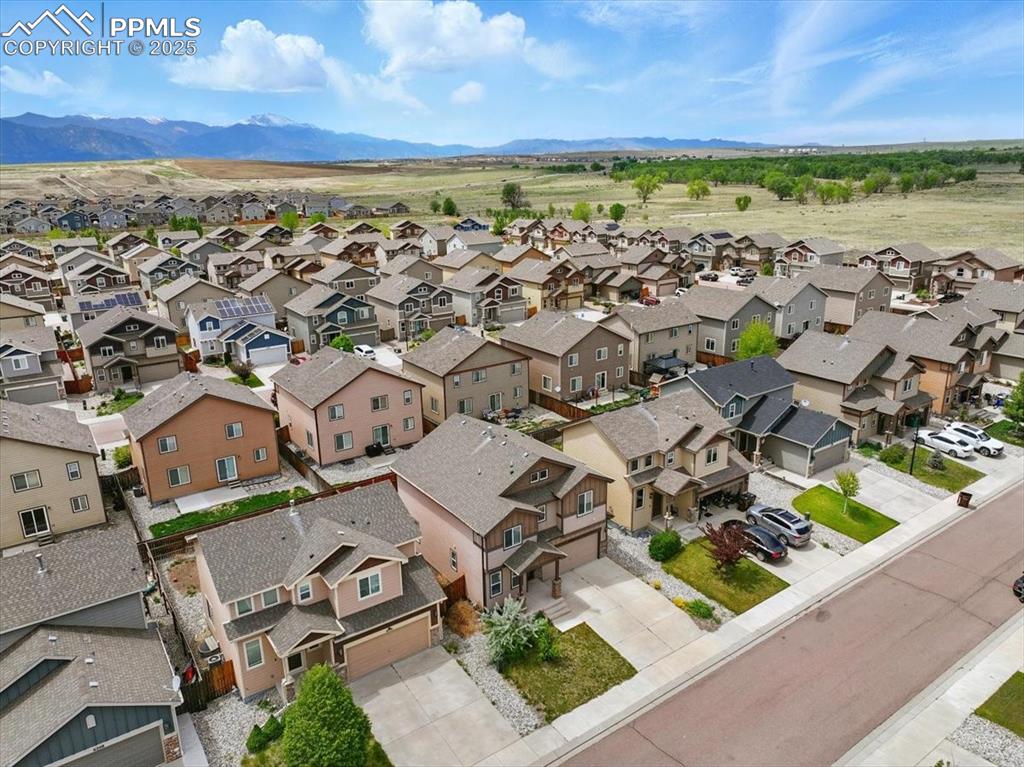Image 46 of 46: Aerial perspective of suburban area with mountains