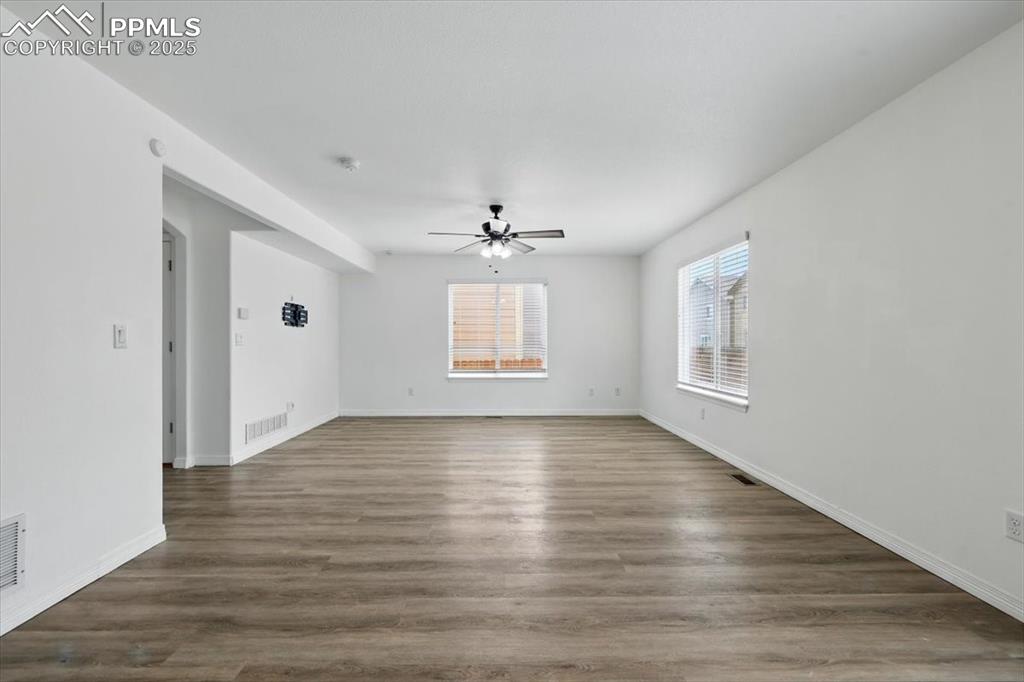 Image 6 of 46: Family or living room with a ceiling fan, baseboards, and wood finished flo