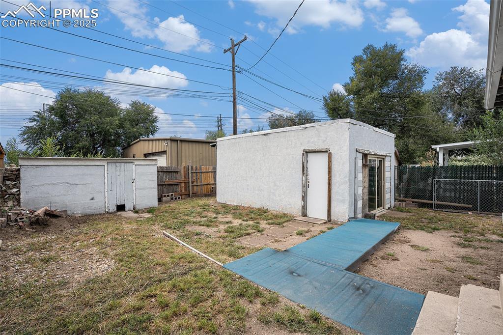 Image 10 of 12: Spacious yard with 2 car detached garage and shed