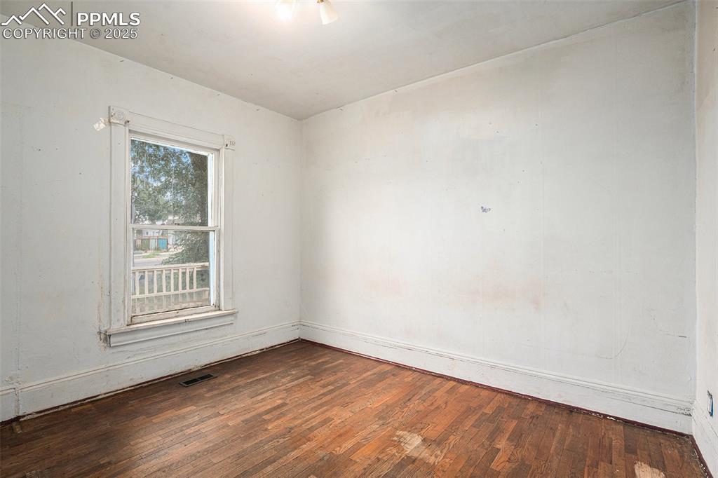 Image 6 of 12: Master bedroom with hardwood floors