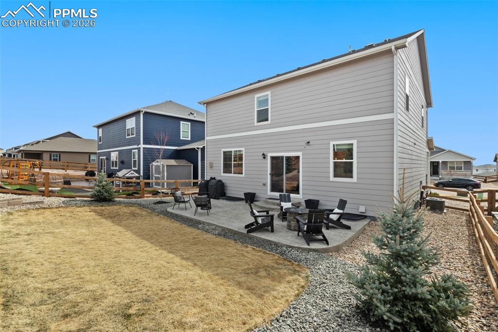 Image 35 of 43: Custom landscaping and large stamped concrete patio