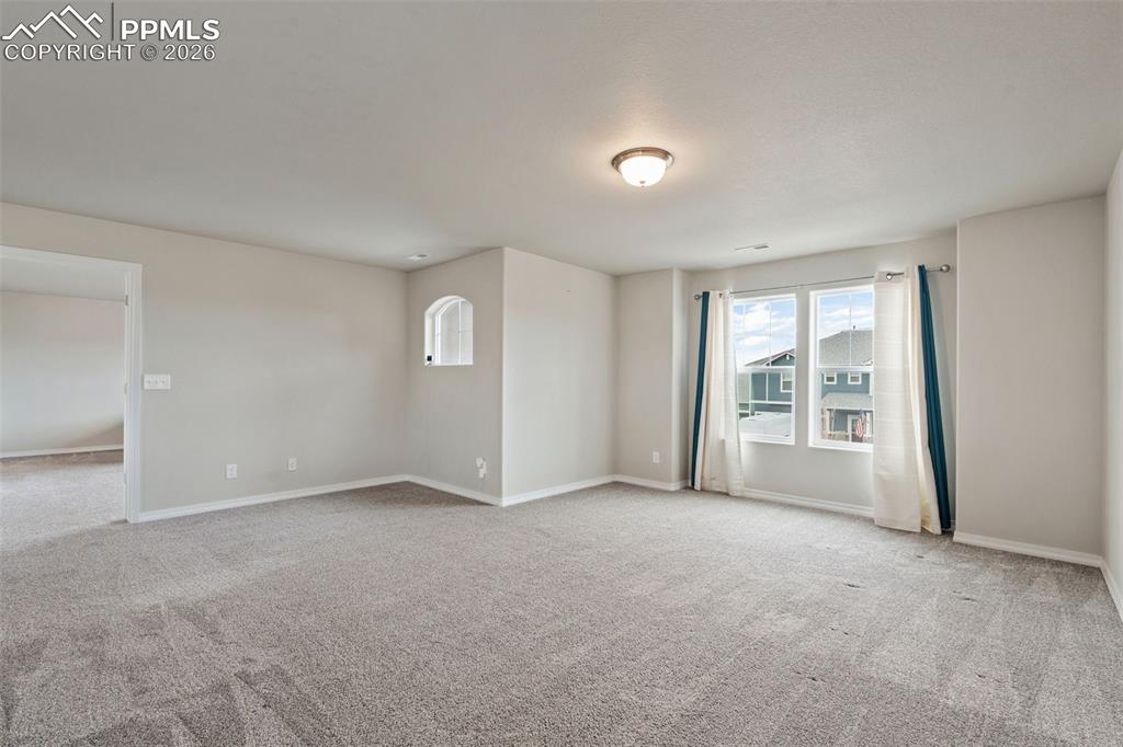 Image 29 of 50: Spare room featuring light colored carpet