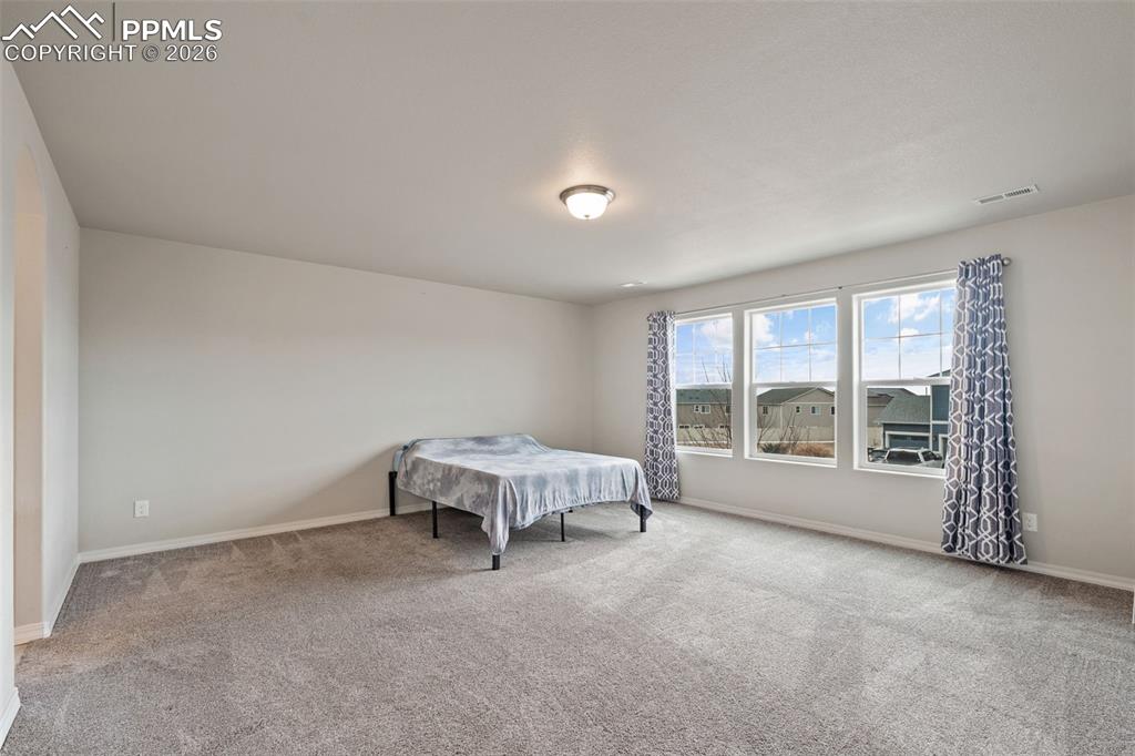 Image 32 of 50: Carpeted bedroom with baseboards