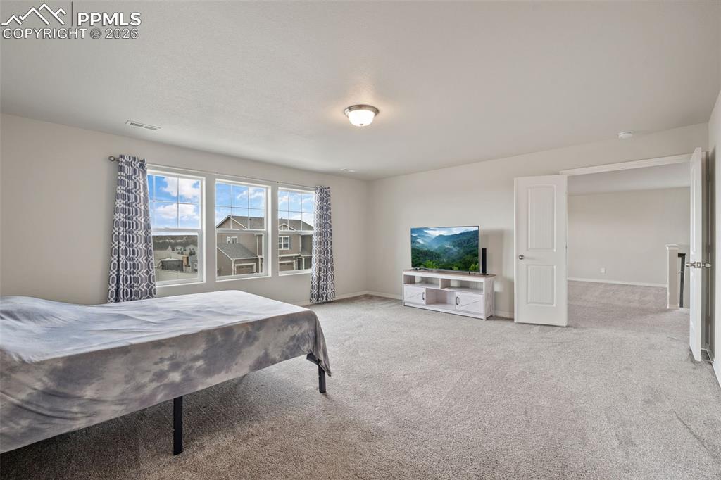 Image 33 of 50: Carpeted bedroom featuring baseboards