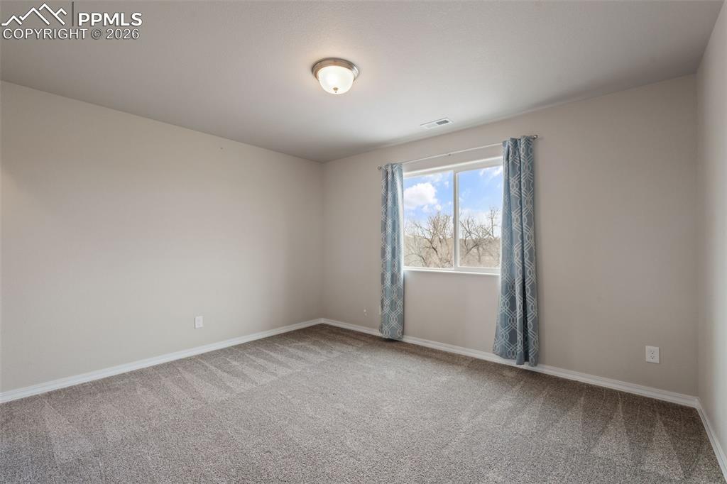 Image 43 of 50: Carpeted empty room with baseboards