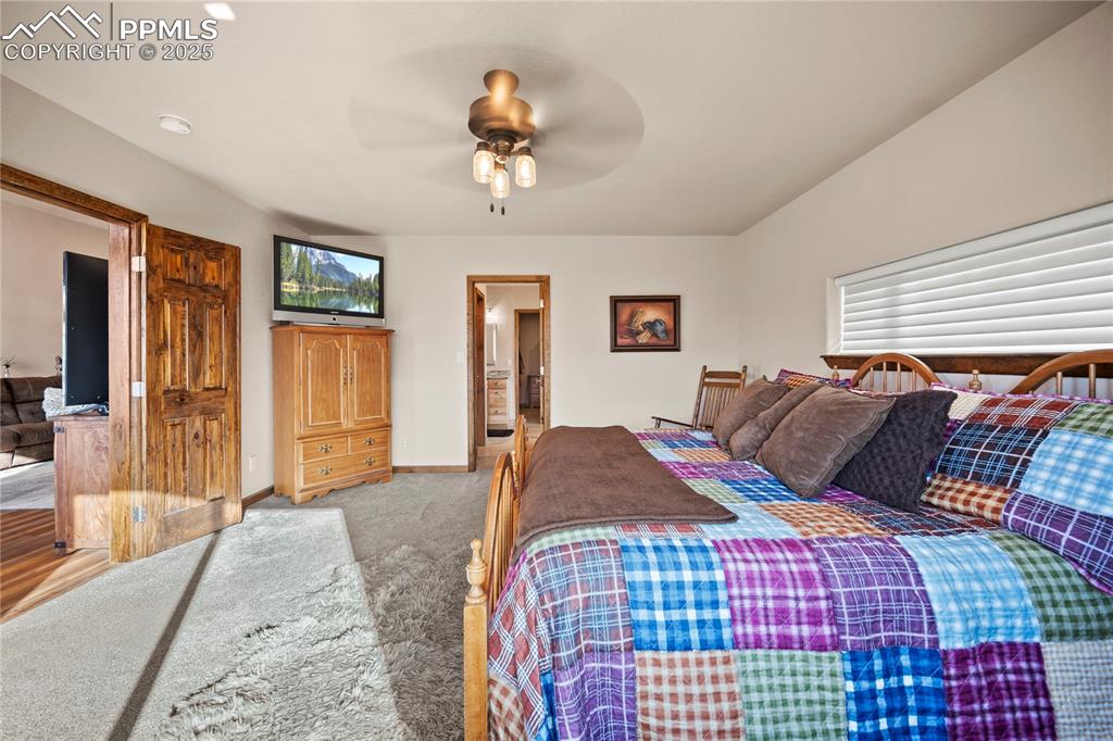 Image 18 of 49: primary suite w/ double doors and ensuite bathroom