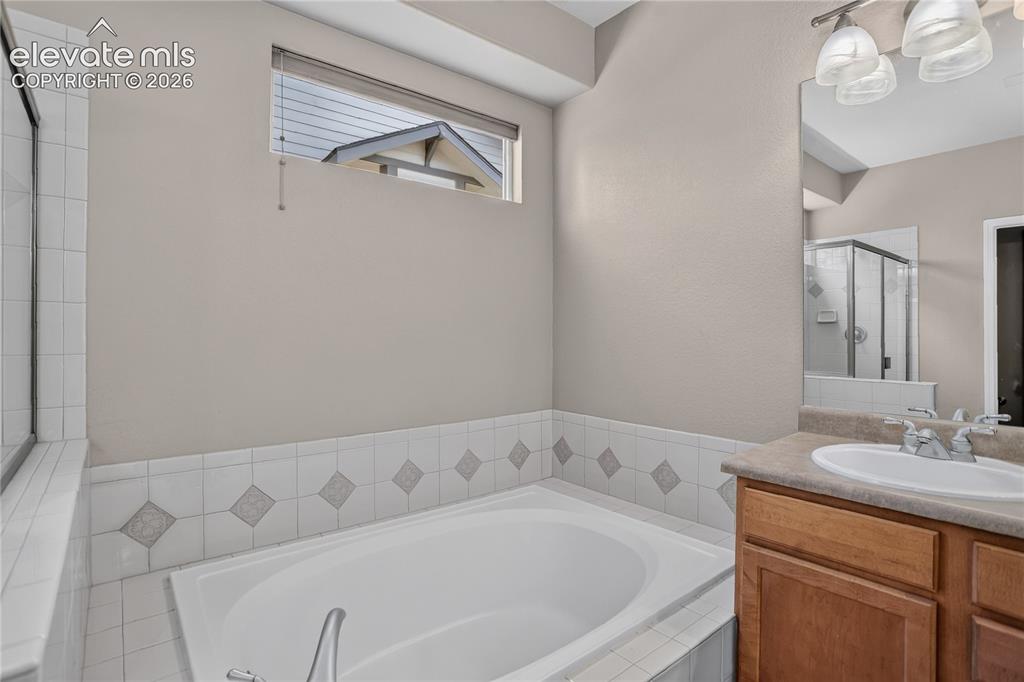Image 23 of 45: Primary bath has in ceiling speaker wiring