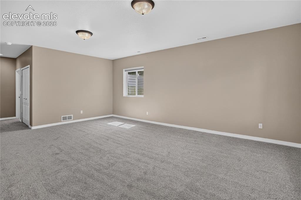 Image 26 of 45: New carpet throughout and surround sound wiring ready for speakers.