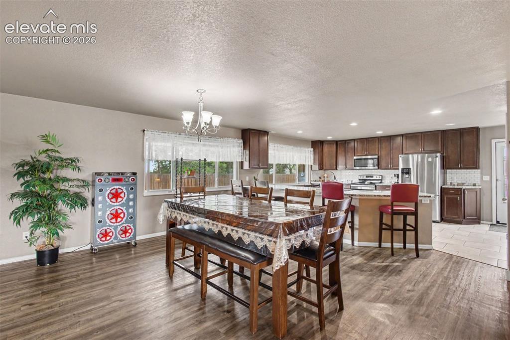 Image 10 of 45: Open and inviting dining room centrally located in the home, providing a na