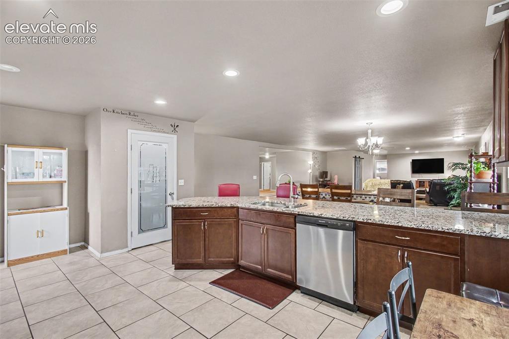 Image 13 of 45: Large glass-door pantry offers abundant storage with a stylish display.
