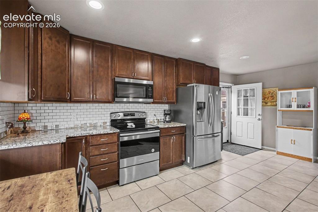 Image 14 of 45: Bright and functional kitchen featuring a convenient walkout to the outdoor