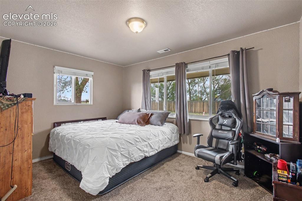 Image 19 of 45: Comfortable secondary bedroom offering a peaceful space for guests, family 