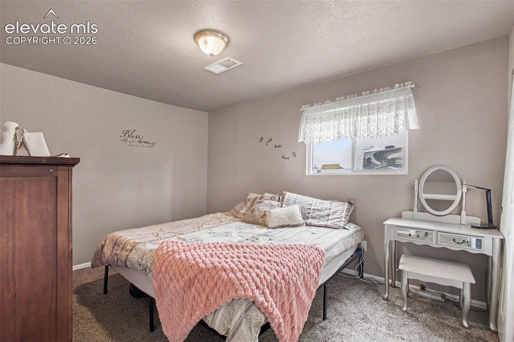 Image 20 of 45: Welcoming 3rd bedroom with a cozy feel, providing flexibility for guests,