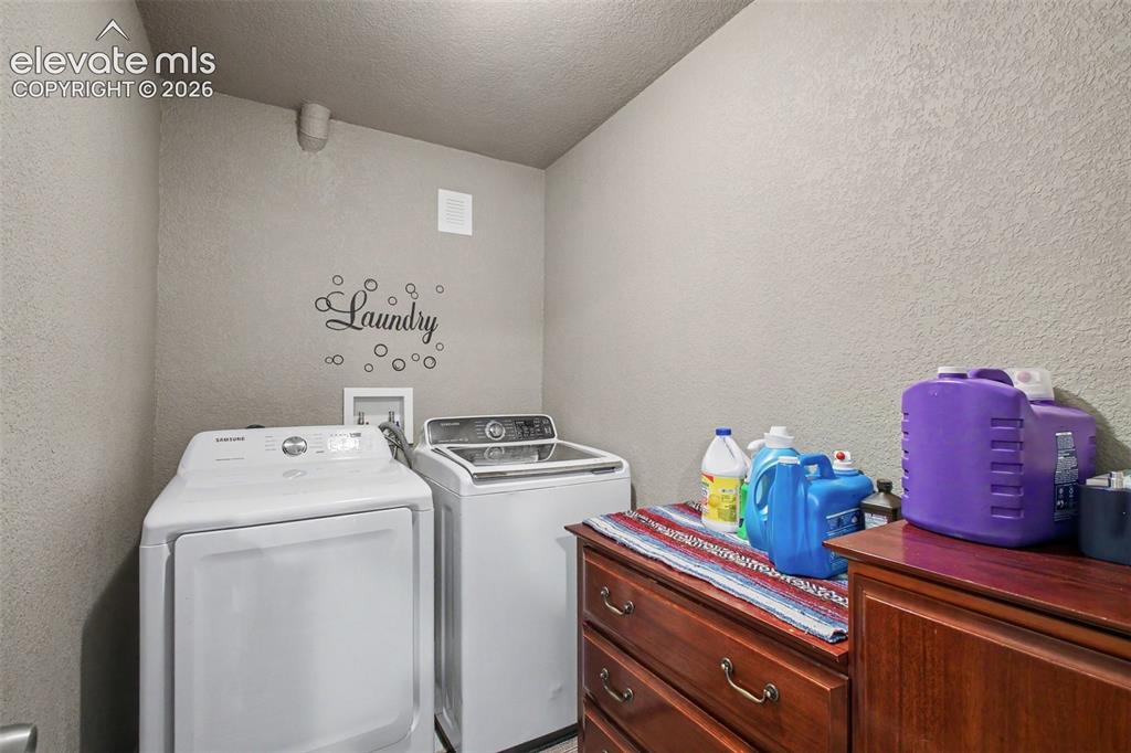 Image 23 of 45: Convenient laundry room with practical space for everyday chores and storag