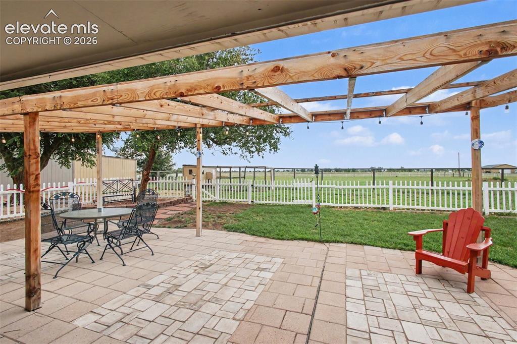 Image 25 of 45: Beautiful outdoor retreat featuring a pergola with Edison lights, open spac