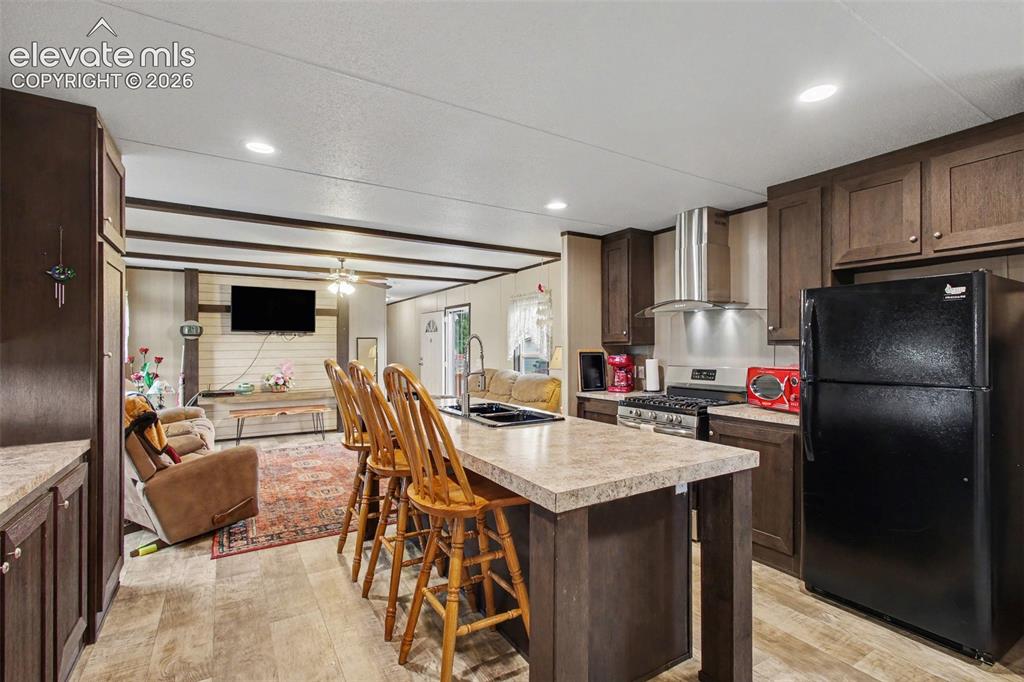 Image 30 of 45: 2nd Home: Functional center island adds extra workspace and a convenient ga