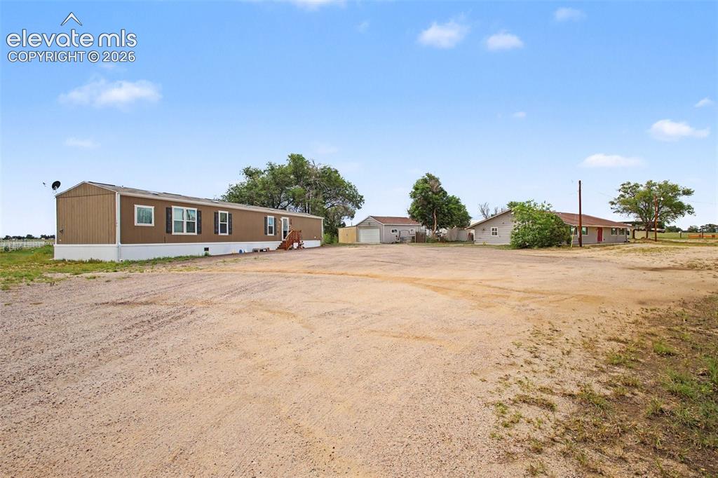 Image 41 of 45: Abundant parking between the 2019 manufactured home and main home, with con