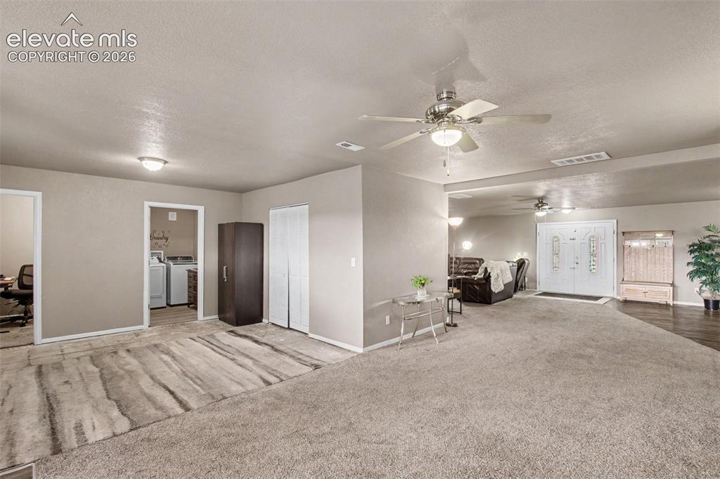 Image 7 of 45: Airy family room seamlessly flowing into the dining area and conveniently c