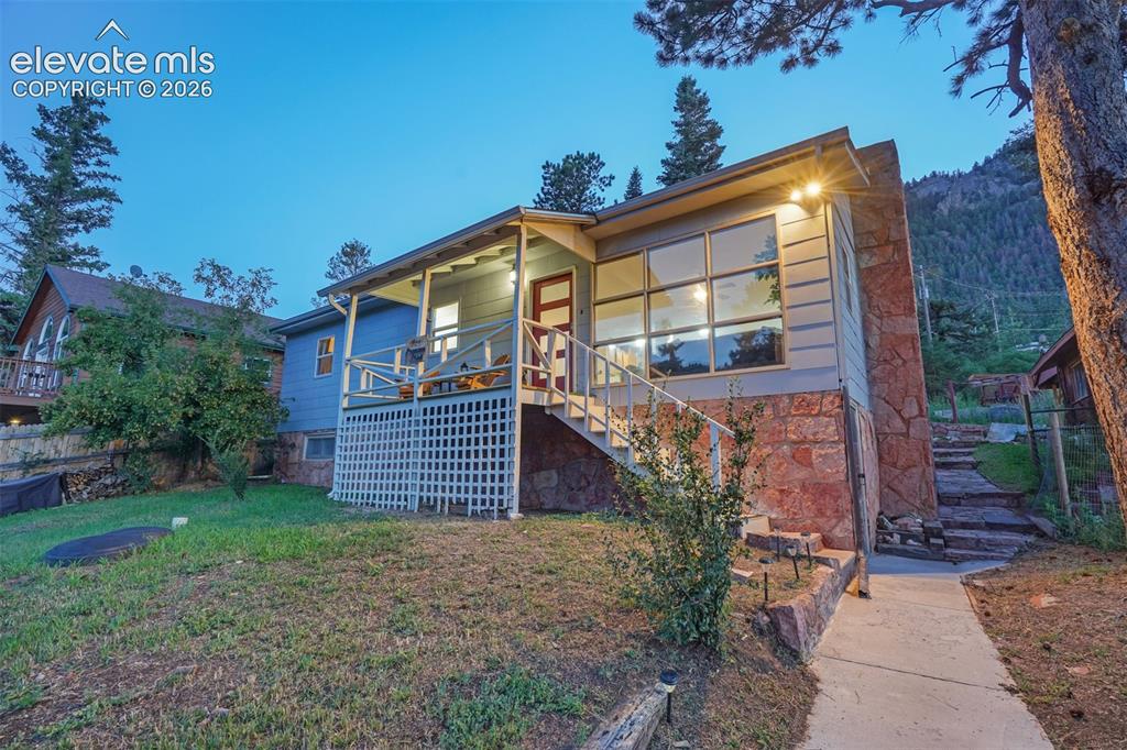 Image 1 of 41: Expansive stone accents and siding exterior with a covered front porch