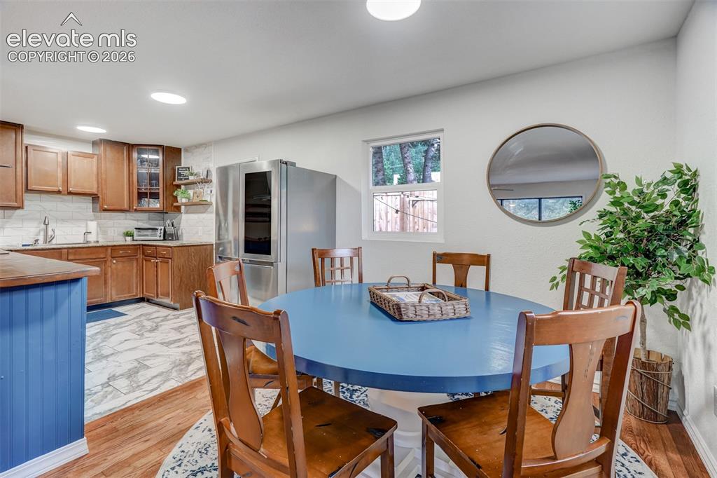 Image 16 of 41: Kitchen featuring wood-finish cabinetry, tile backsplash, and stainless ste