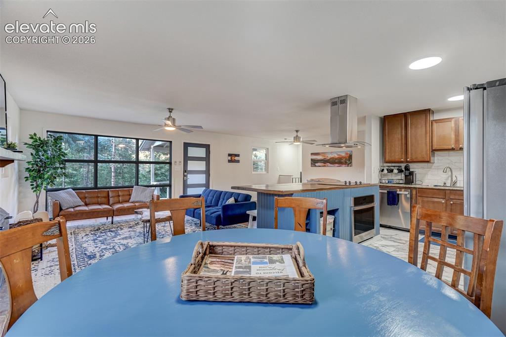 Image 17 of 41: Open concept living space featuring a kitchen island, recessed lighting, an