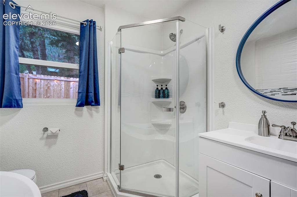Image 24 of 41: White vanity with an integrated sink and brushed nickel faucet