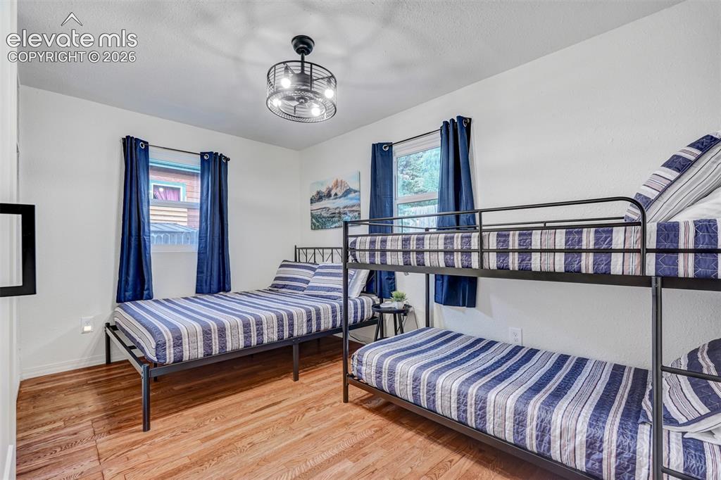 Image 25 of 41: Wood-finish flooring with white walls and dual windows