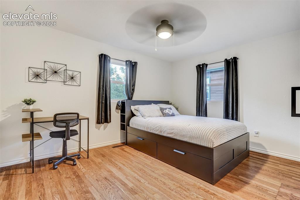 Image 27 of 41: Wood-finish flooring, white walls, and a ceiling fan with integrated lighti