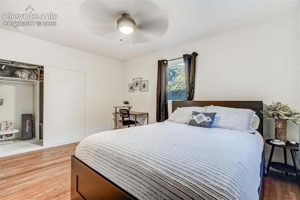 Image 28 of 41: Recessed lighting, wood-finish flooring, ceiling fan, and sliding closet do