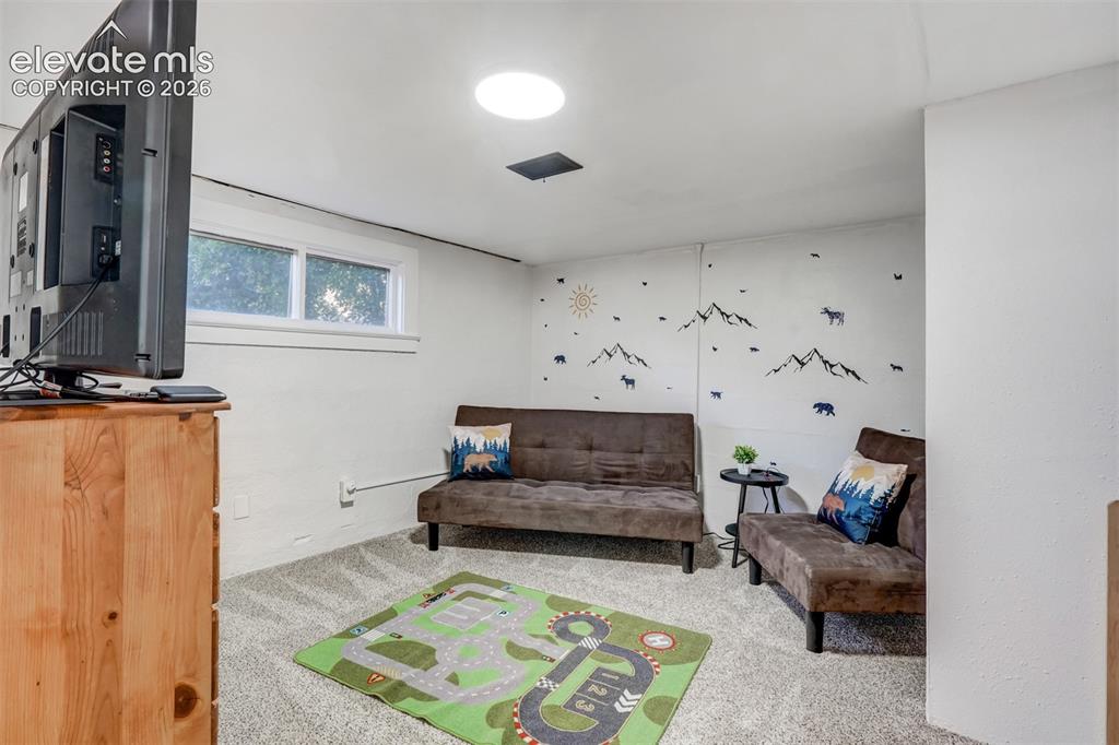 Image 39 of 41: Recessed lighting, wall-to-wall carpeting, and a window for natural light