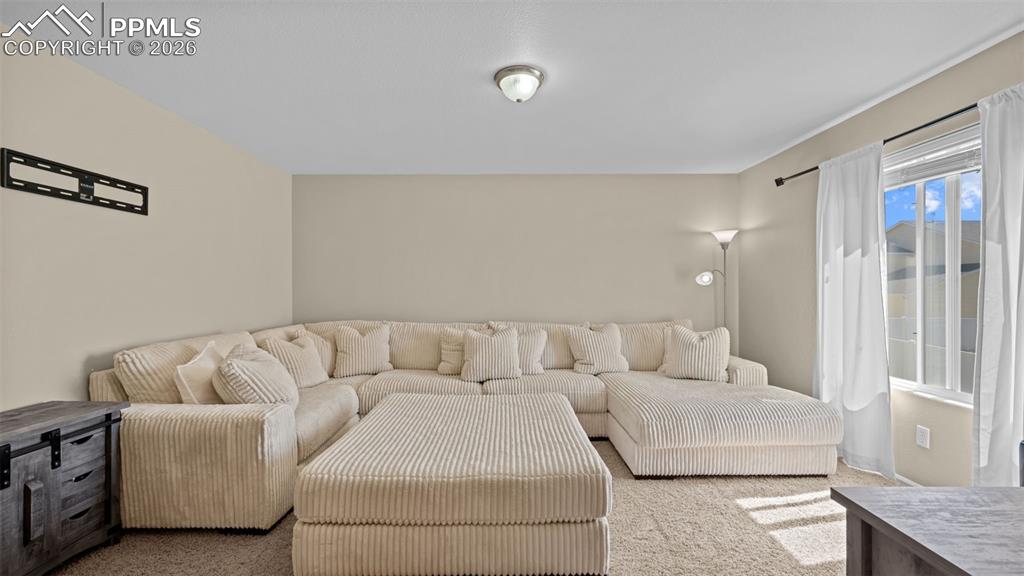 Image 18 of 37: Bedroom featuring light carpet and a ceiling fan