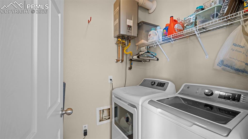 Image 28 of 37: Kitchen featuring black appliances, wood finish cabinets, light countertops