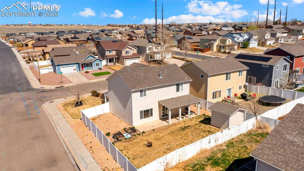 Image 3 of 37: Aerial view of residential area featuring a mountainous background